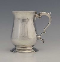 A George III silver mug, of baluster form, the double C scroll handle with acanthus leaf thumbpiece,