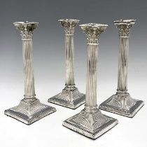 A set of four Victorian silver Corinthian column candlesticks, modelled in the Neoclassical style,