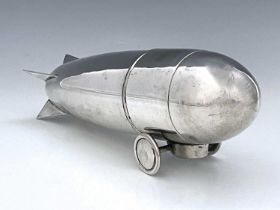 A twentieth-century novelty metal cocktail shaker, modelled in the form of a Zeppelin, the sectional