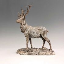 An Elizabeth II hallmarked silver model of a stag, the body decorated to simulate hair, atop a