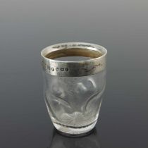 Christopher Dresser, (Attributed). A Victorian silver mounted glass tot cup, the glass body with