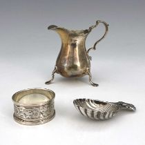 Three twentieth-century hallmarked silver items, to include a milk or cream jug, modelled in the
