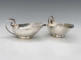 R. E. Stone A pair of George VI silver sauce boats, the planished body with scroll handle formed