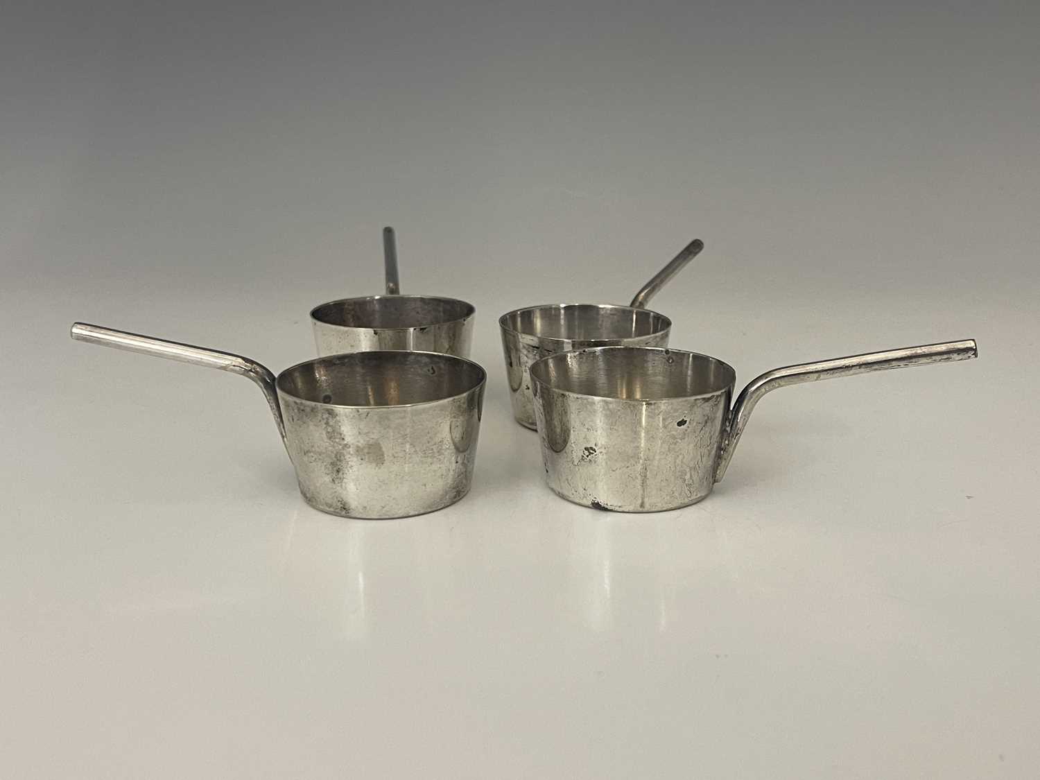 A set of four twentieth-century silver plated novelty miniature saucepans, apparently unmarked,