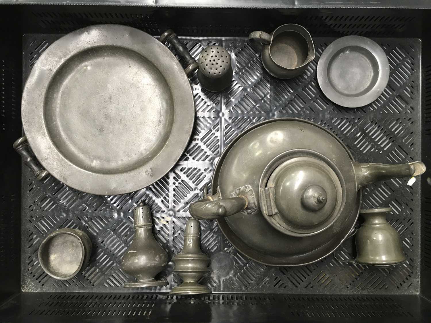 A collection of 18th century and later pewter including sahkers, salts, chargers etc., some marked