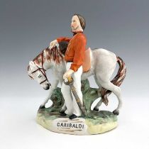 A Staffordshire figure of Garibaldi, by Thomas Parr, circa 1865, modelled standing beside his horse,