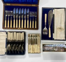 A collection of plated and stainless steel boxed flatware including a set of fish knives and