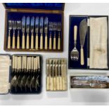 A collection of plated and stainless steel boxed flatware including a set of fish knives and