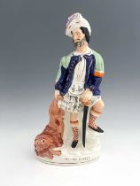 A large Staffordshire figure 'The Lion Slayer', circa 1860, modelled as an impressive bearded figure