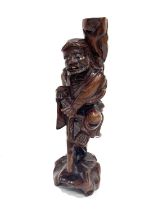 A Chinese root carving of an elder, standing holding a knarled staff, 31cm high