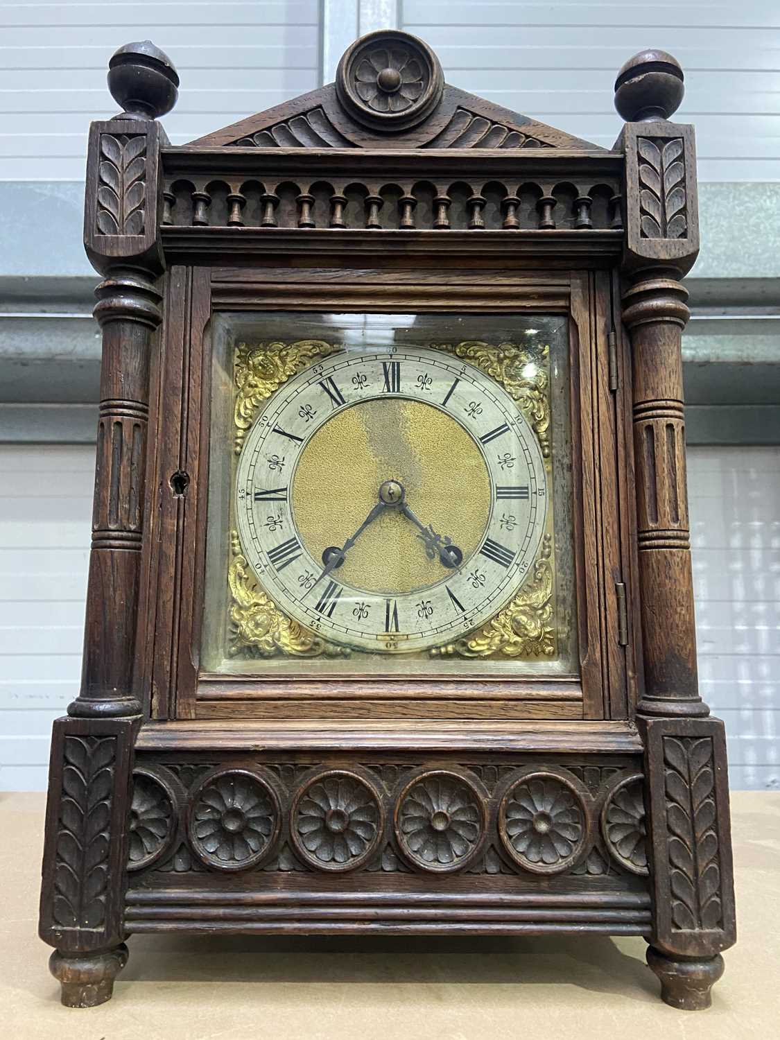 A German carved oak Aesthetic Movement mantel clock, architectural case, with silvered chapter