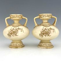 A pair of Royal Worcester twin handled vases, ovoid footed form, date code 1886, ivory gorund with