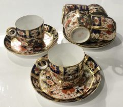 A collection of Davenport Imari pattern coffee cups and saucers