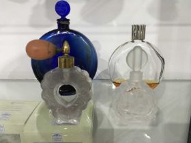 Two Lalique scent bottles, including blue glass Worth example, together with a Lalique glass