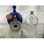 Two Lalique scent bottles, including blue glass Worth example, together with a Lalique glass