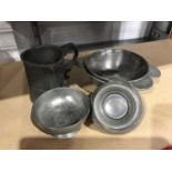 A collection of late 18thC early 19thC English pewter to include four bowls and a tankard