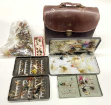 A large quantity of fishing flies, some boxed, some loose, together in a leather case