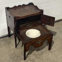 A George III mahogany bedside commode, shaped upstand over a cupboard with double doors, a drawer
