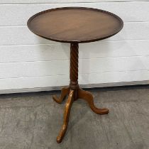 A small circular occasional table, with a barley twist column, on downward sweeping tripod