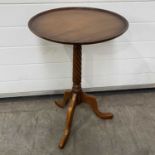 A small circular occasional table, with a barley twist column, on downward sweeping tripod