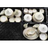 A Wedgwood part dinner service with gilded ivy border on ivory ground ( 3 trays )