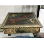 A brass and painted metal slipper box, wedge form with embossed and planished lid, 40cm wide