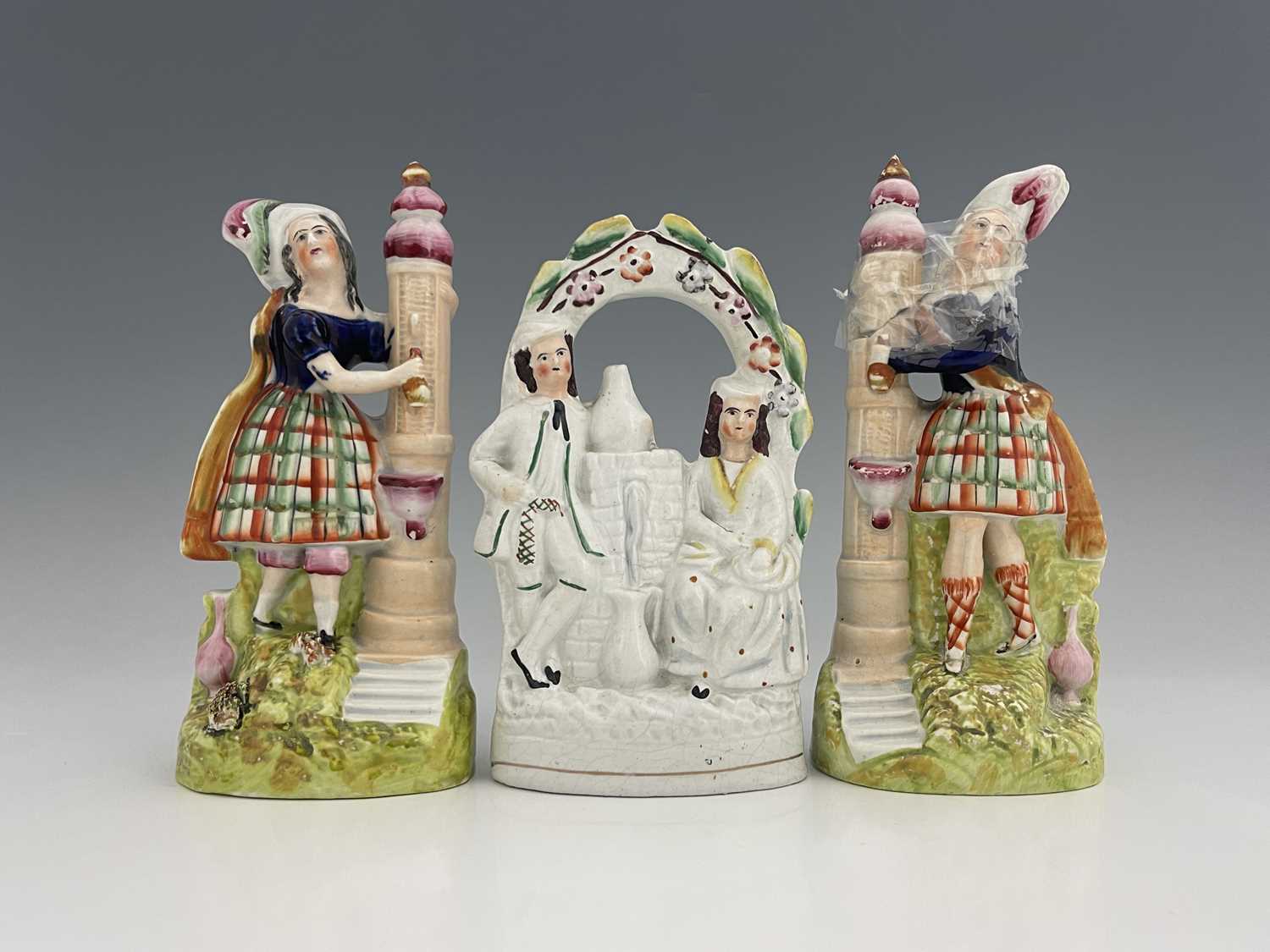 Staffordshire temperance figures collecting water from a fountain, circa 1860, figures modelled as a