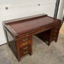 A mahogany Globe Wernicke desk, tambour D shaped cover with fitted interior, over three frieze