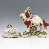 A Staffordshire figure group of children with dogs, circa 1860, larger figure modelled as a girl