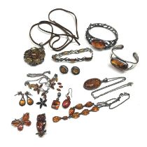 Two silver amber pendants, three bracelets set with amber, two brooches, necklace and earrings,