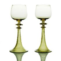 A pair of Arts and Crafts green glass Roemer type hock glasses, probably Rheinische Glashutten,