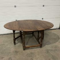 A traditional oak gate leg table, on turned and block supports. W: 174 cm D: 125 cm H: 75 cm