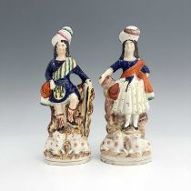 A pair of Staffordshire shepherd and shepherdess figures in Scottish Highland dress, circa 1850,