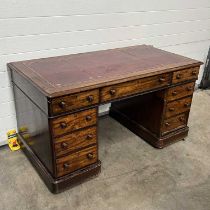 A multi-part desk, with a red and gilt tooled leather writing surface, fitted one long drawer,