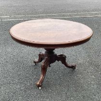 A circular occasional table, carved tripod supports, on castors Diameter: 113 cm H: 74 cm