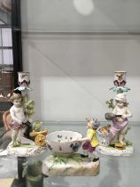 A Meissen figural table salt, modelled as a font and standing child, on shaped naturalistic base,