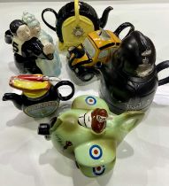 A collection of novelty teapots including: a couple dancing, marmite, policeman, taxi, piano, RAF