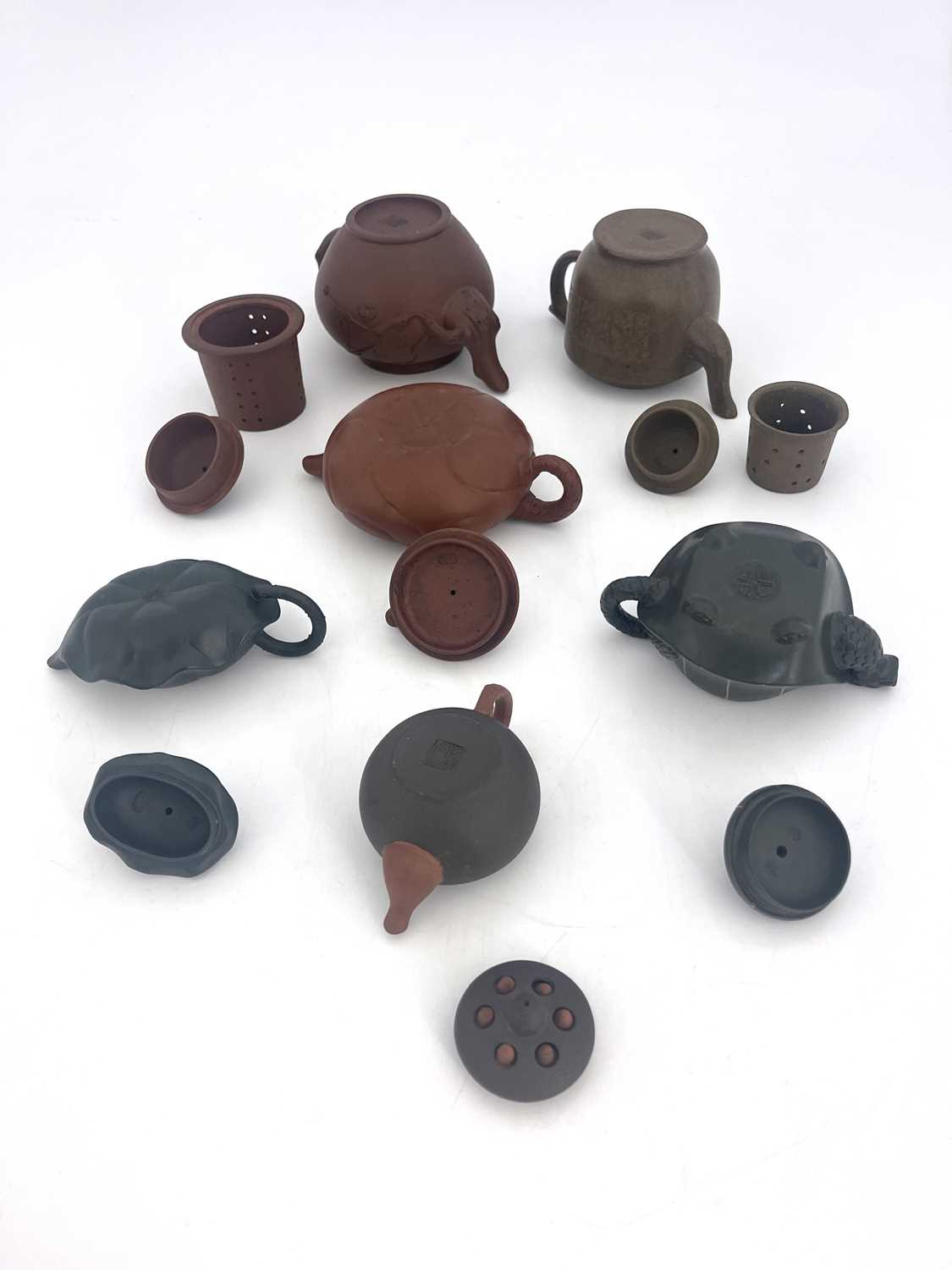 Six Oriental earthenware teapots, relief moulded figural and zoomorphic designs in terracotta and - Image 5 of 5