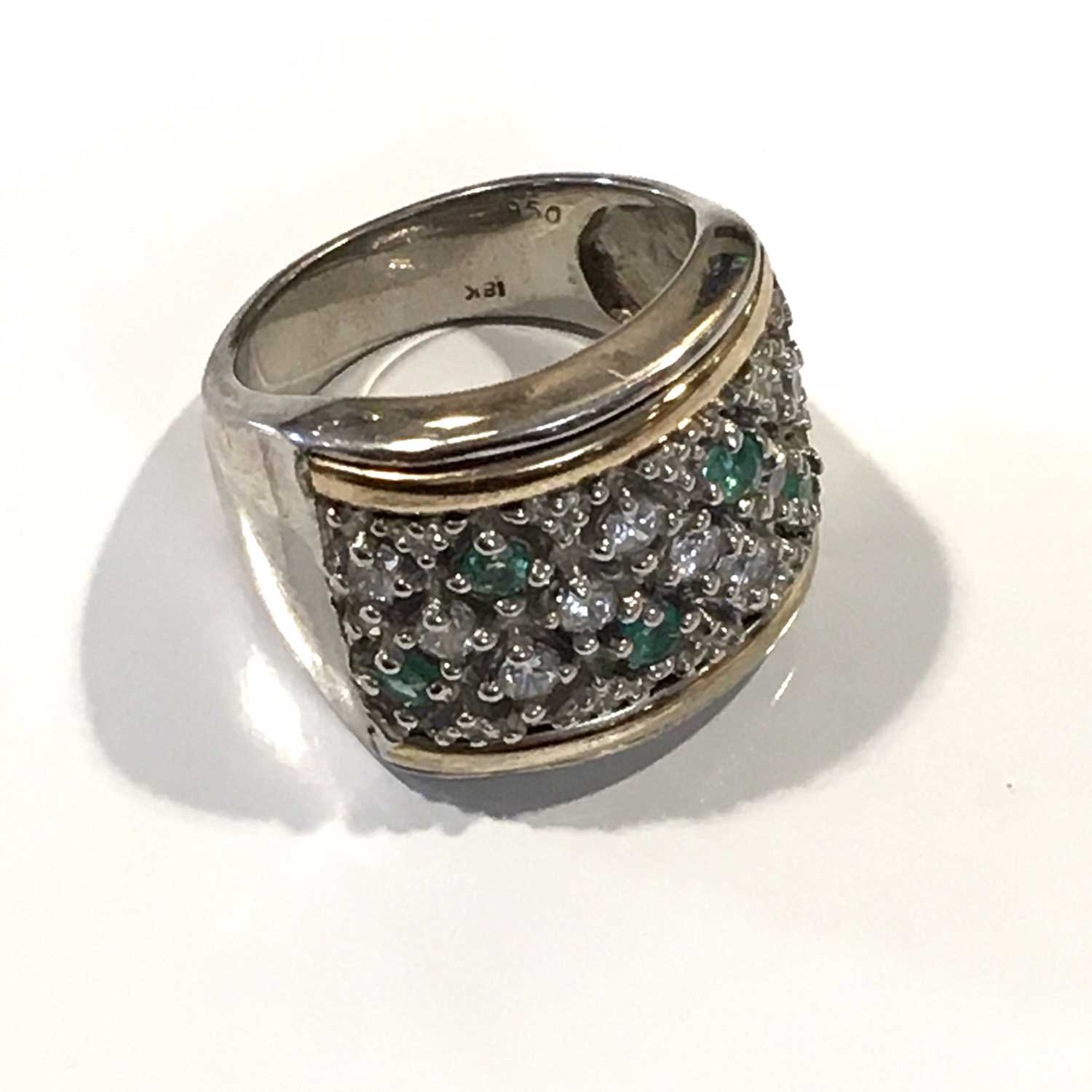 A silver and gold, emerald and cubic zirconia dress ring