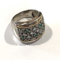 A silver and gold, emerald and cubic zirconia dress ring