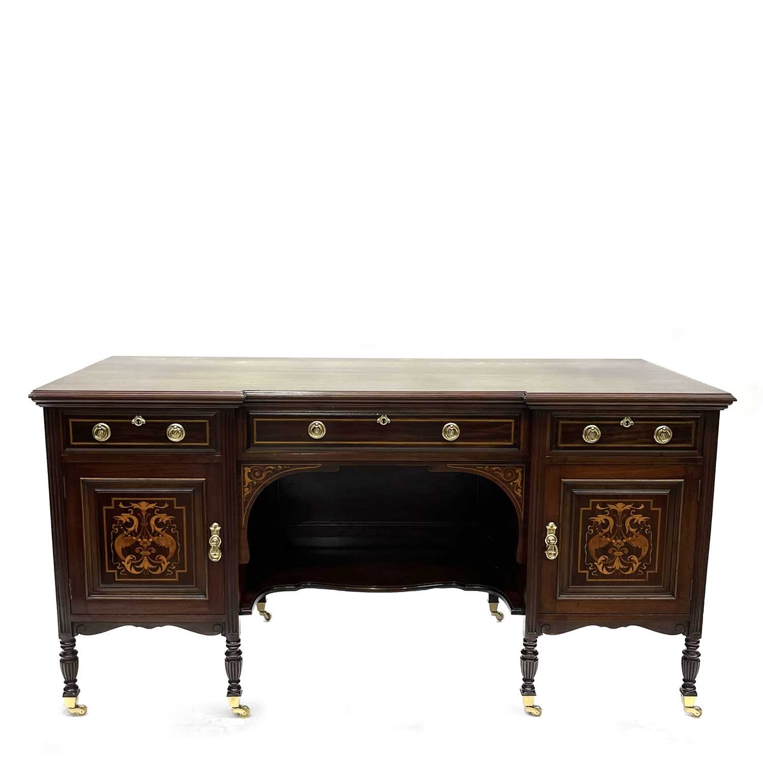 An Edwardian mahogany breakfront writing table, circa 1910, crossbanded and marquetry inlaid, triple