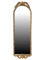 A gilt framed arch wall mirror 33 x 105 cm