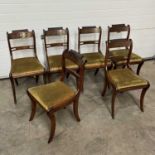 A set of brass-inlaid, regency-style dining chairs, with drop in seats, on sabre supports (6)
