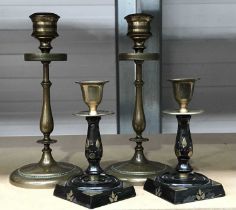 A pair of bronze candlesticks, circa 1880, finely case, with diaper pattern frieze, on slender