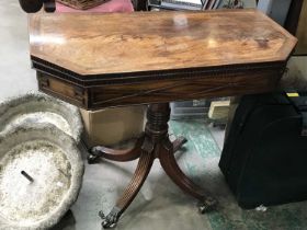 George III Mahogany fold over card table, crossbanded and octagonal form on turned columns and