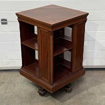 A mahogany boxwood strung and marquetry inlaid revolving bookcase, on castors W: 49 cm D: 49.5 cm H: