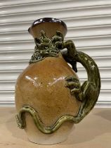 Large stoneware jug with applied, stylised three-dimensional green dragon snaked around the