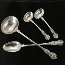 A silver plated Queens pattern soup ladle, a basting spoon, and a pair of sauce ladles (4)