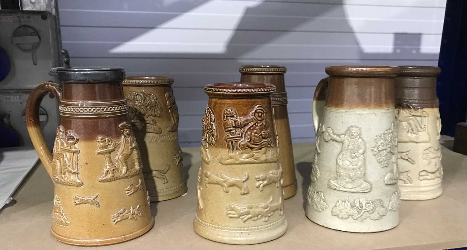 A collection of stoneware saltglazed mugs, in the style of the Mortlake and Vauxhall factories,