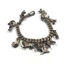 An early 20th silver charm bracelet, with assorted charms